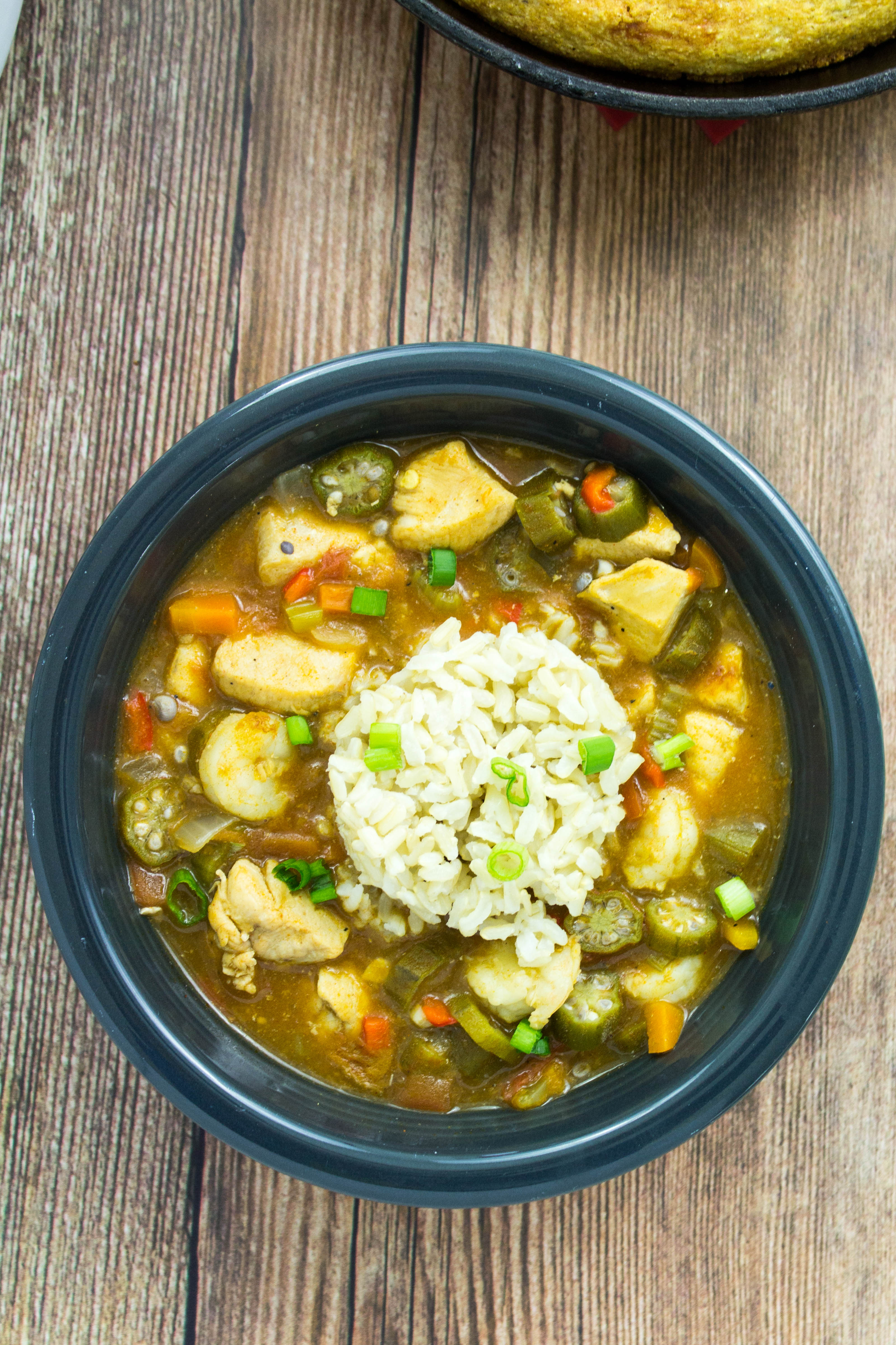 Chicken & Shrimp Gumbo is a healthy twist on the classic Cajun dish. Diced chicken, vegetables, okra, & shrimp cooked in a decadent, perfectly spiced broth is delicious with every bite. Easy to make & a great way to have Cajun food at home! Weight Watchers friendly recipe! www.bitesofflavor.com